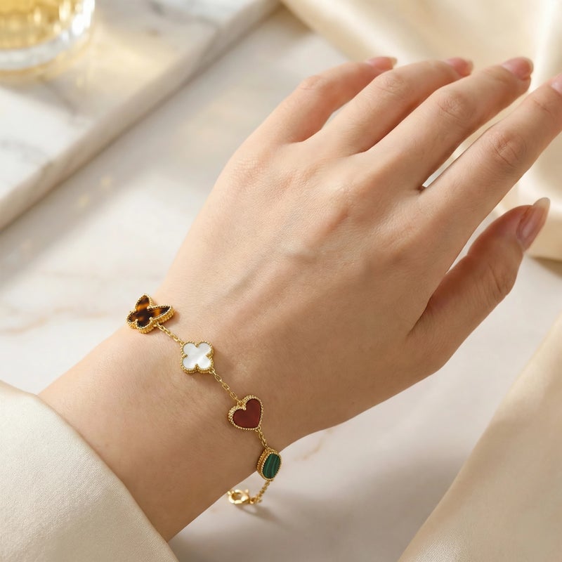 A delicate gold-tone bracelet crafted from rust-resistant stainless steel, adorned with royal green and mother-of-pearl white motifs featuring a butterfly and heart design. It has an adjustable clasp for a perfect fit. - Image 1